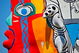 A bold composition of crazy designs and bright splashes of paint, with an eye motif subtly woven into the chaos.