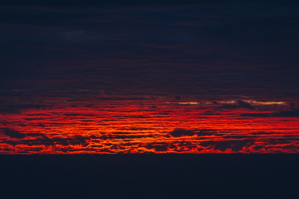 the sun is setting over the clouds in the sky