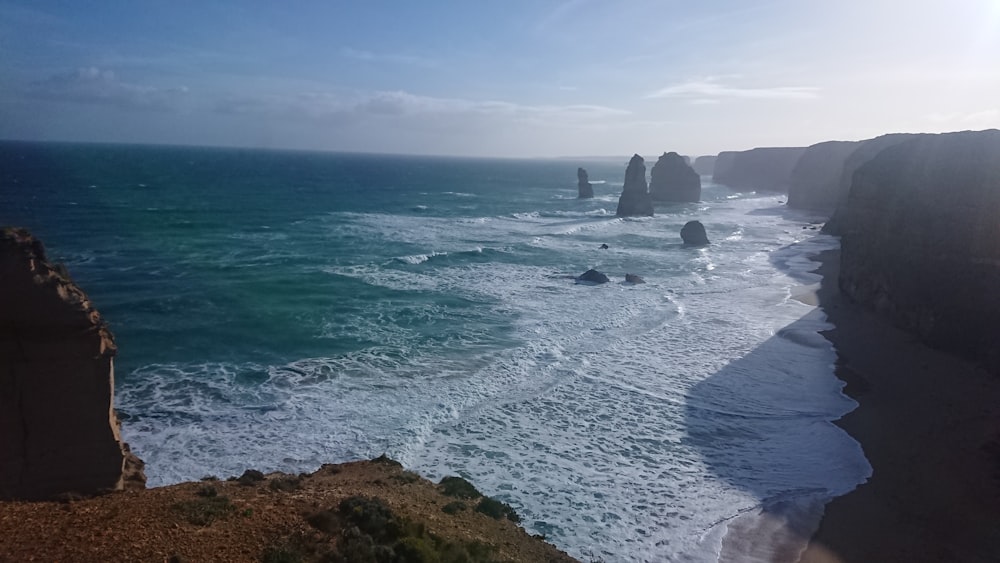 ocean waves crashing on shore during daytime