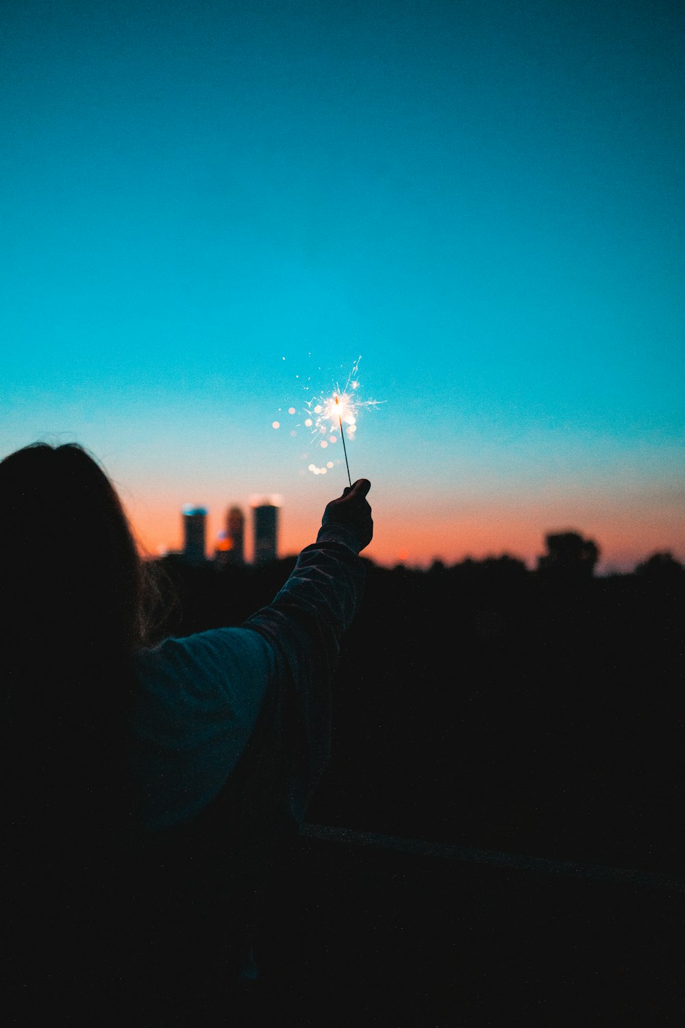 person holding sparkler during night time