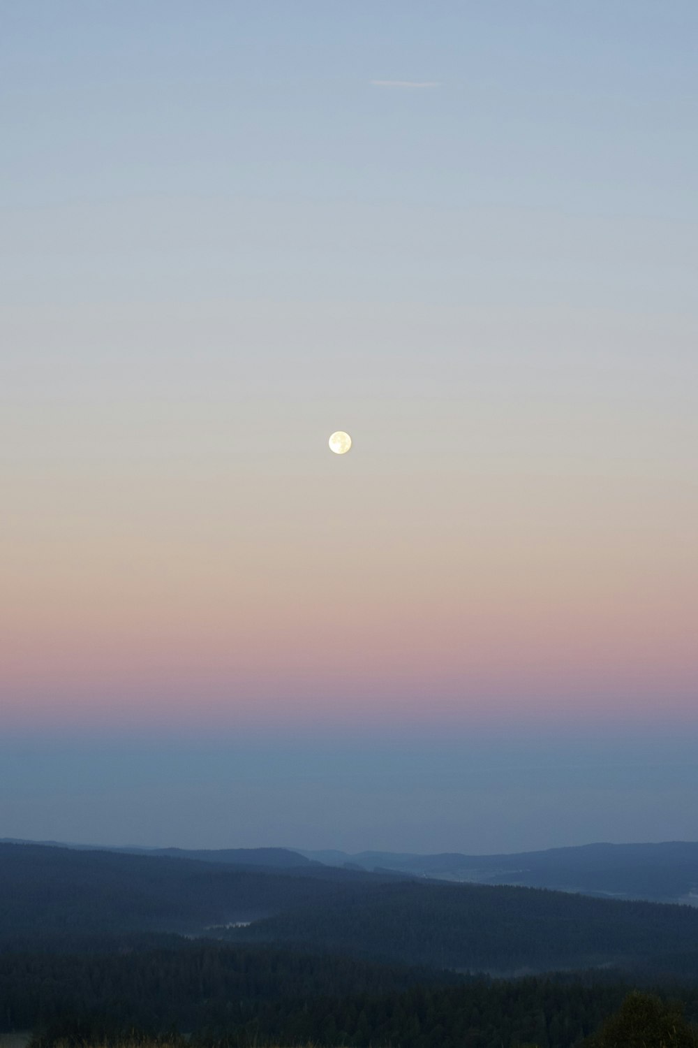 silhouette of mountain under full moon