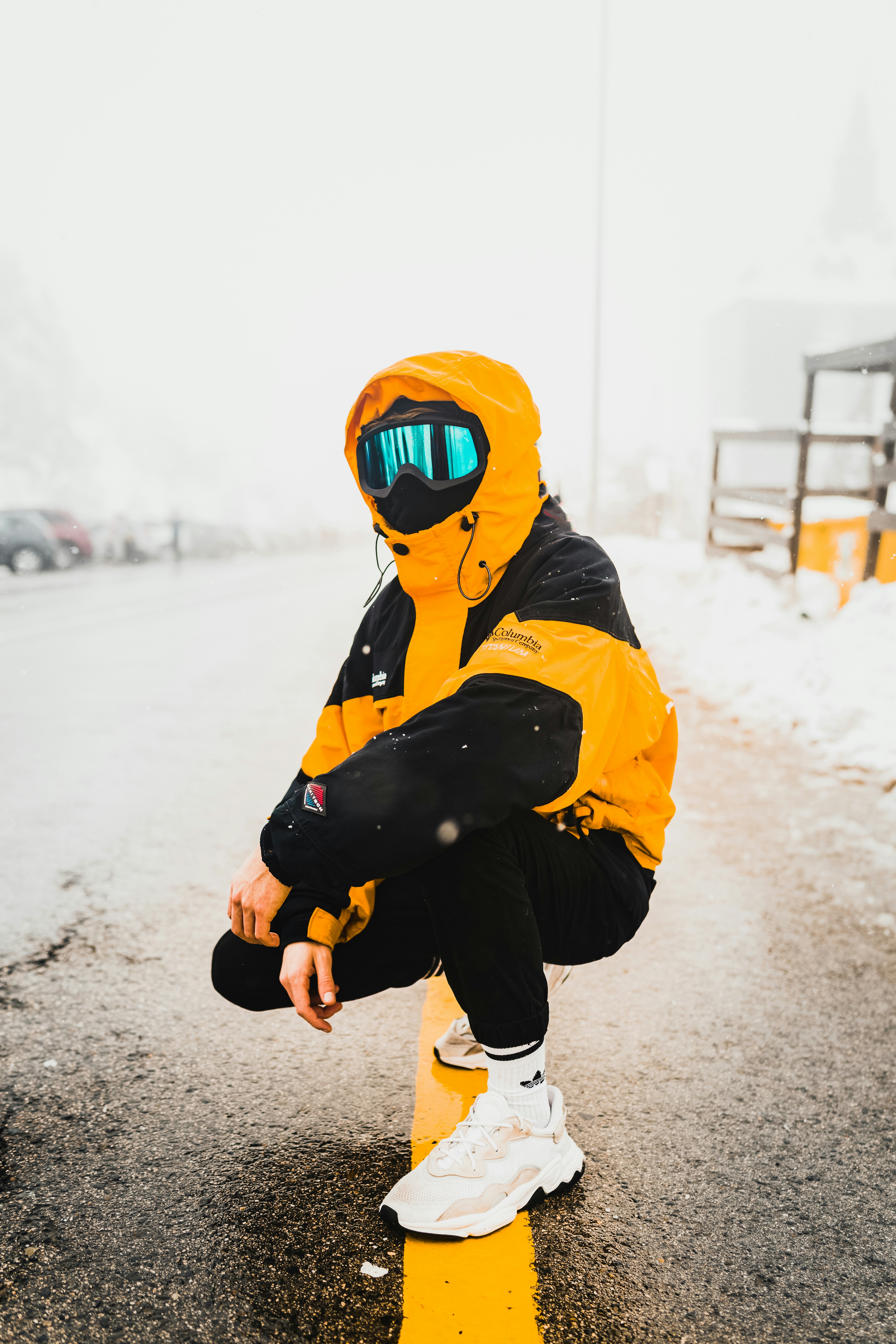 person in yellow and black hoodie wearing mask