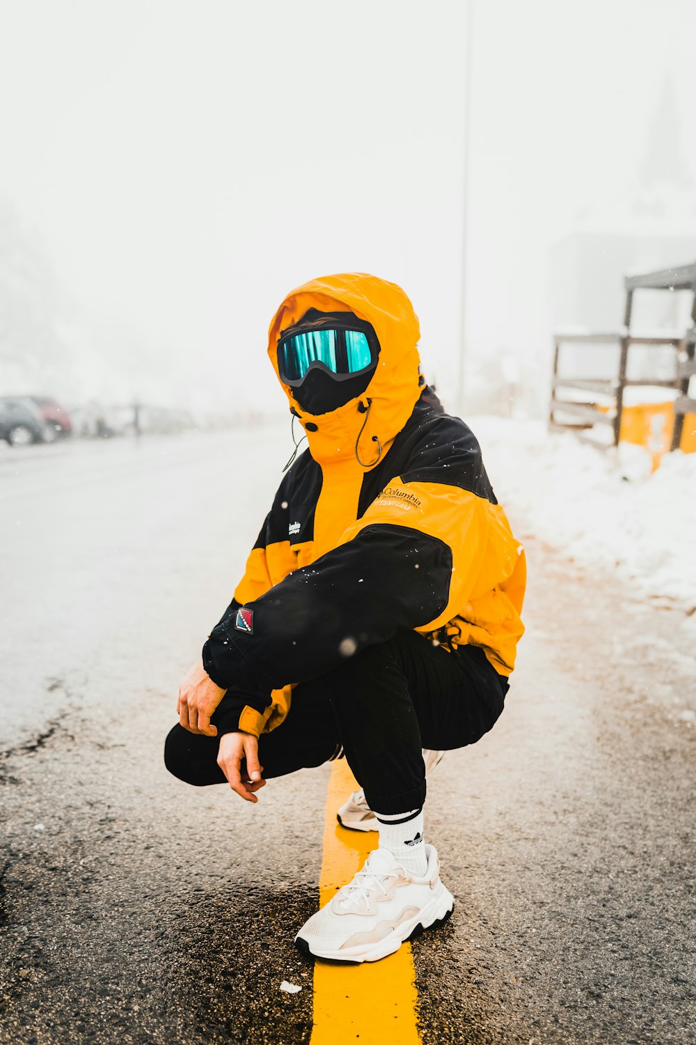 person in yellow and black hoodie wearing mask