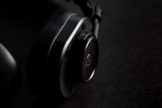 black and silver headphones on brown textile