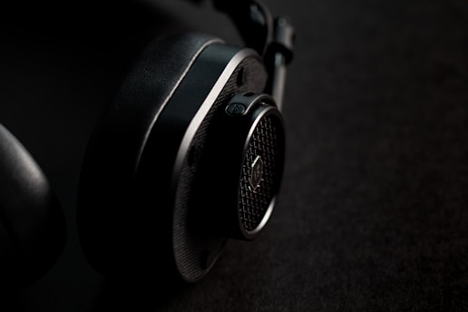 black and silver headphones on brown textile