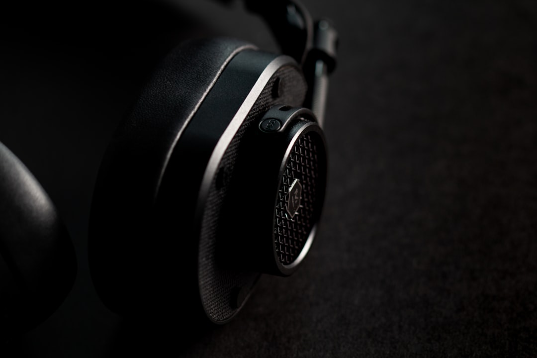 black and silver headphones on brown textile, Master and Dynamic over the ear headphones.