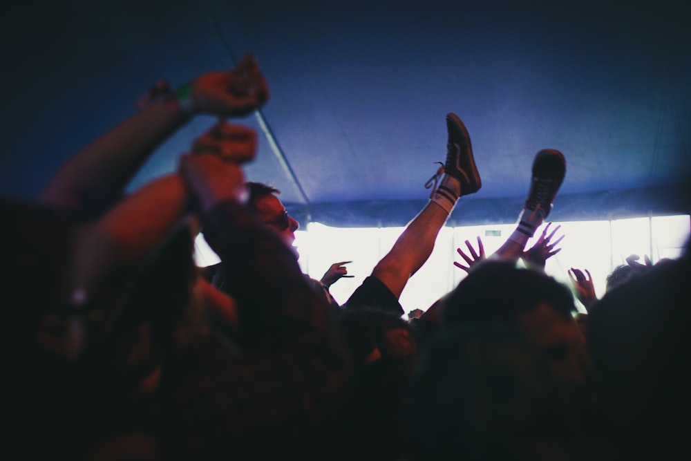 people raising their hands during night time