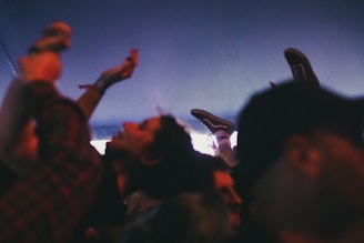 A dynamic crowd enjoying a live hip hop concert outdoors.