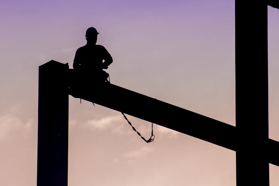 Electrical tradesperson working at height on a utility pole