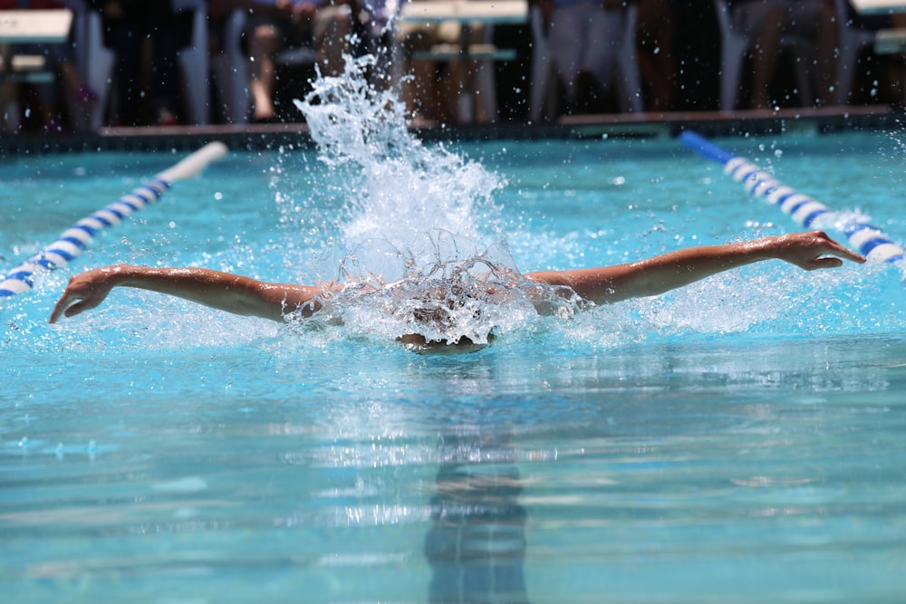 person in blue and white shorts in water