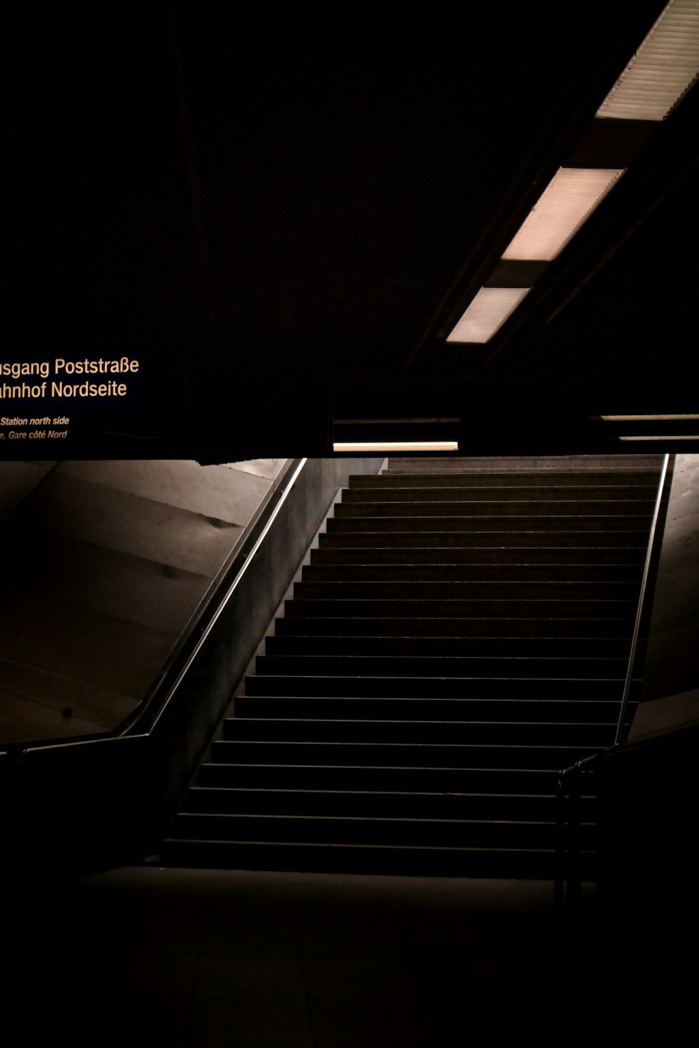 black escalator on black floor
