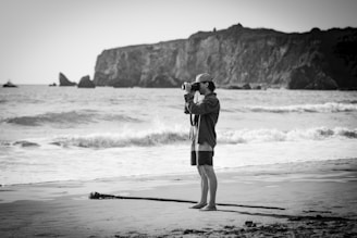 A travel influencer capturing a candid moment on a sun-drenched beach in Bali, waves crashing nearby.