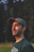 man in black crew neck shirt wearing black hat