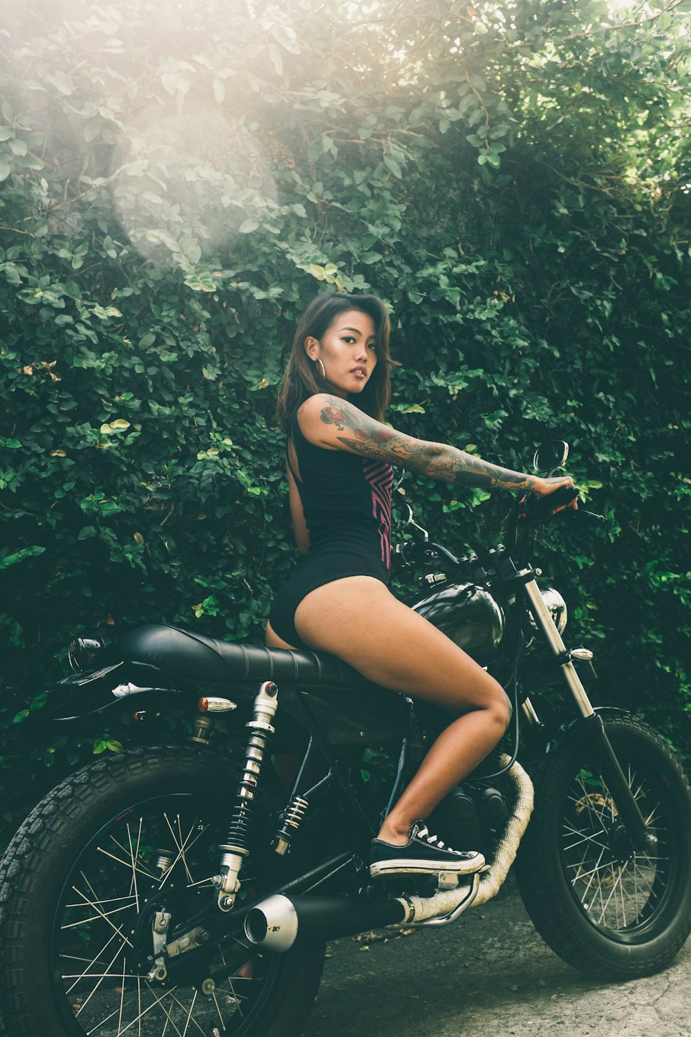 woman in black tank top and black shorts riding on black mountain bike