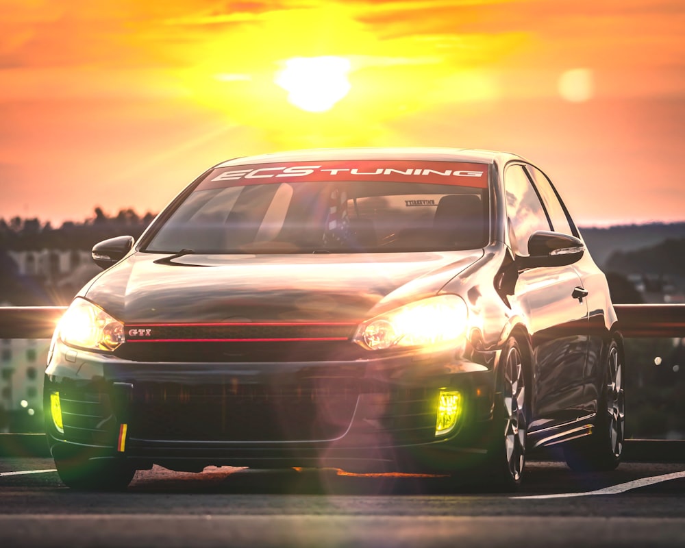 white car on road during sunset