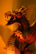 An elegant black dragon with intricate wing patterns displayed on a wooden shelf