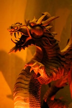 A detailed 3D-rendered dragon wrapped around a glowing orb, showcasing intricate textures and shadows.