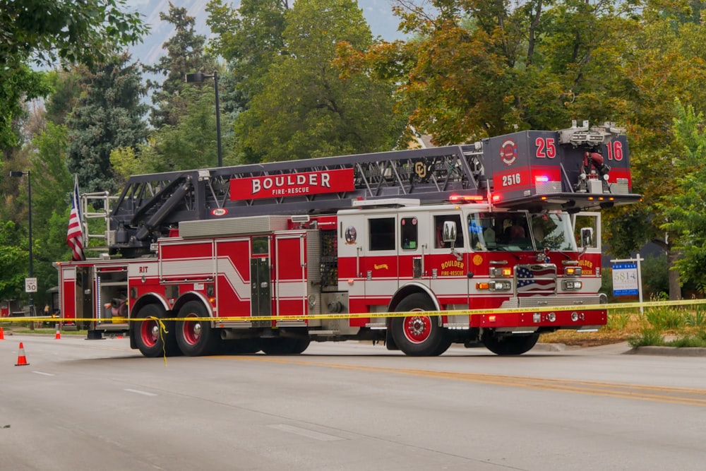 red and white fire truck on road during daytime