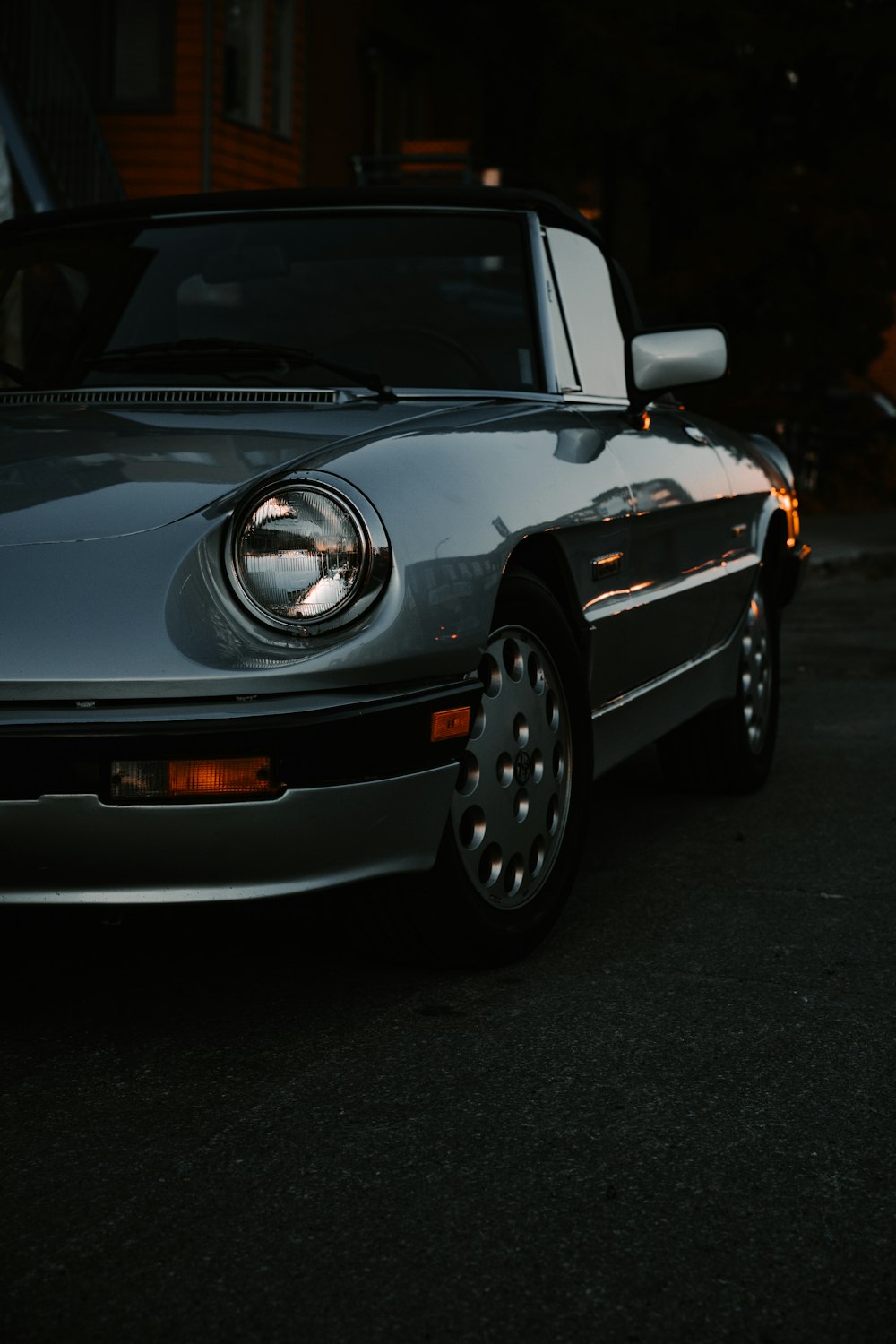 grey porsche 911 parked on grey pavement