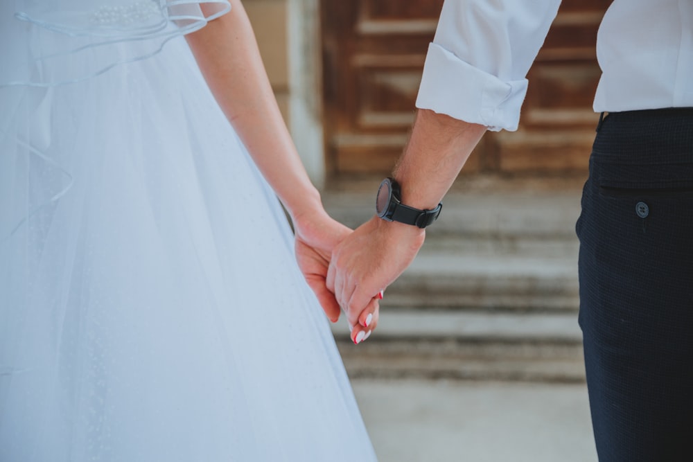 woman in white dress wearing black leather strap watch