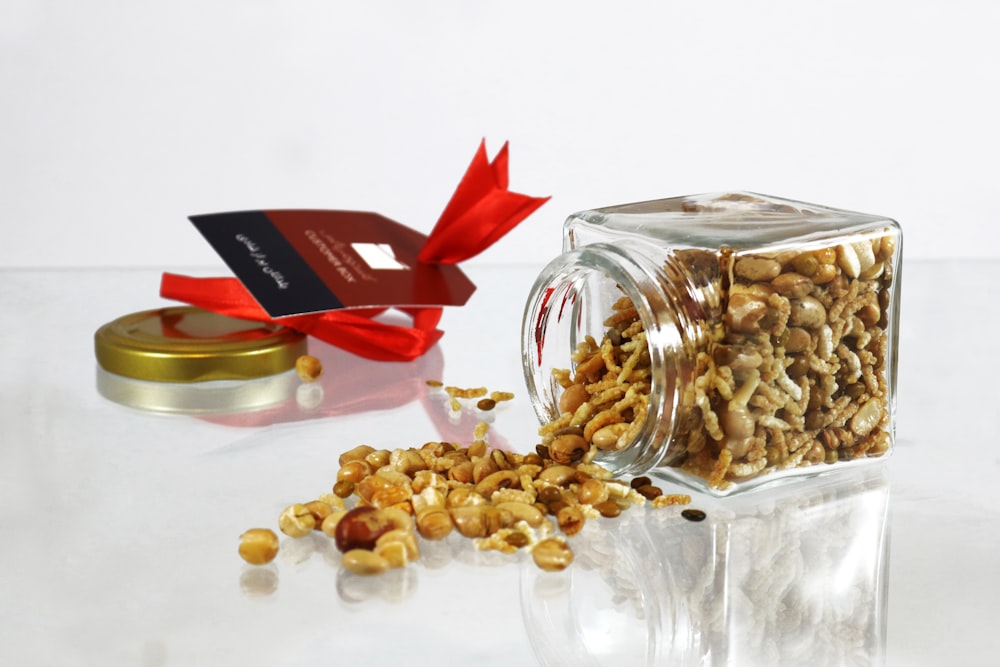 brown peanuts in clear glass jar