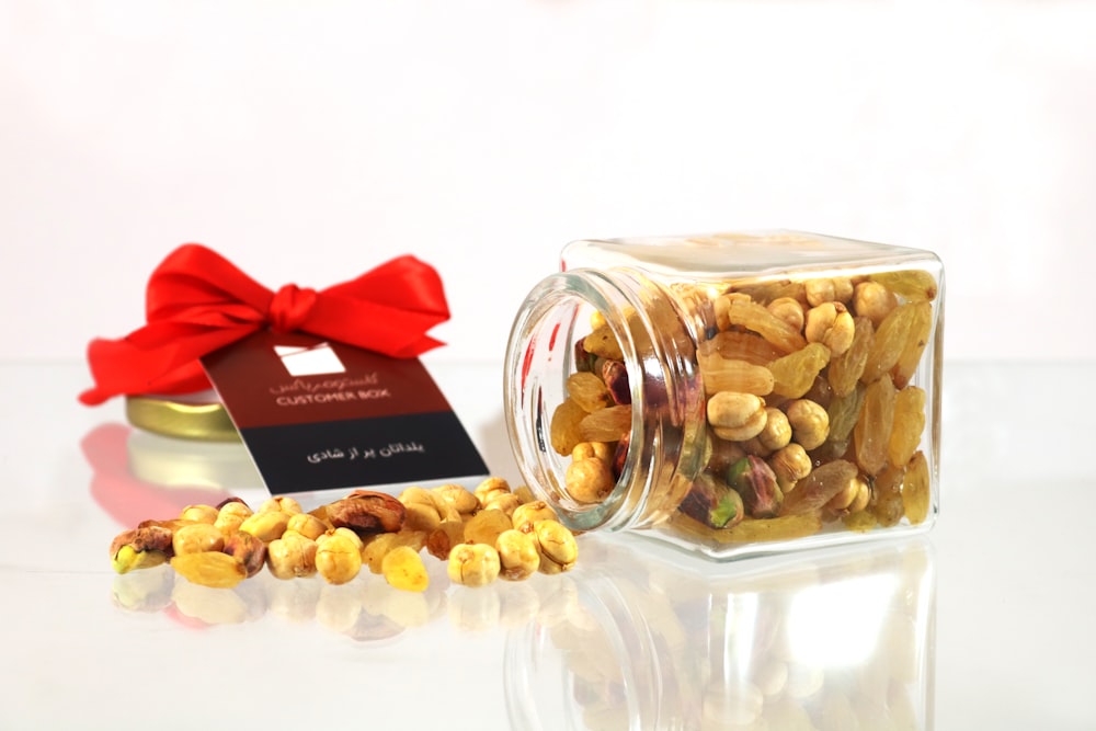 brown peanuts in clear glass jar