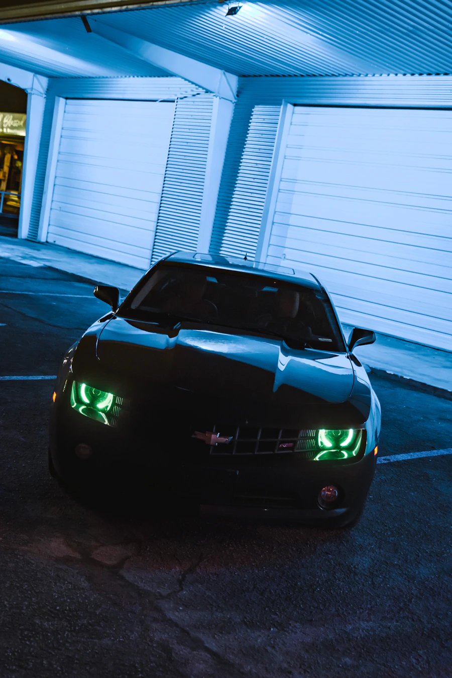 Black sports car in garage lighting