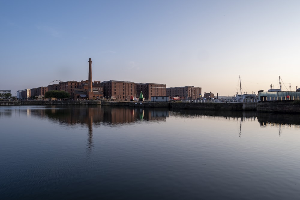 brown and white concrete building beside body of water during daytime