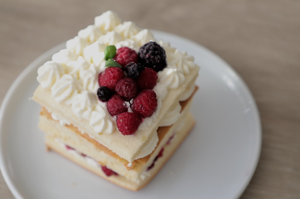 white and brown cake with raspberry on top