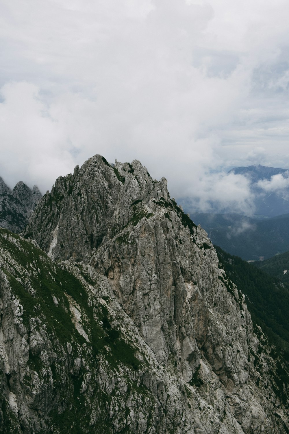 gray rocky mountain under white cloudy sky during daytime