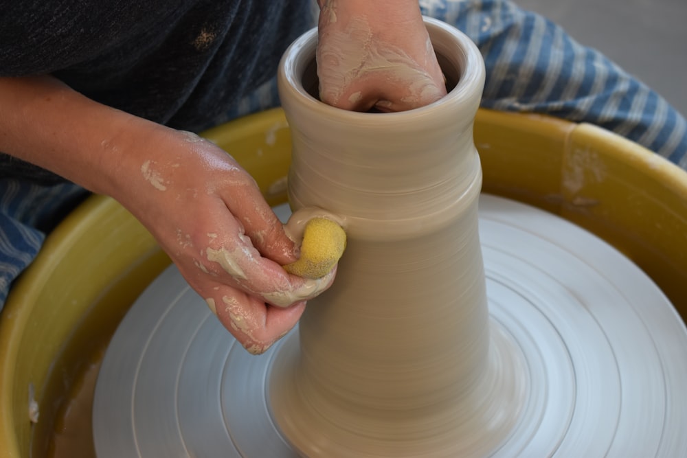 person holding white round ceramic bowl