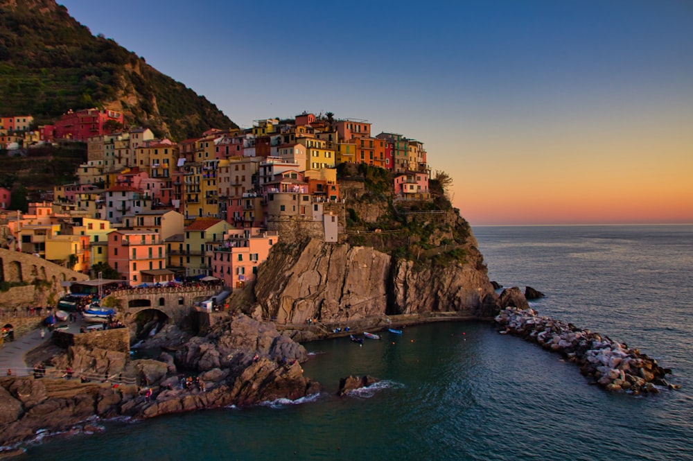 city buildings on cliff beside sea during daytime