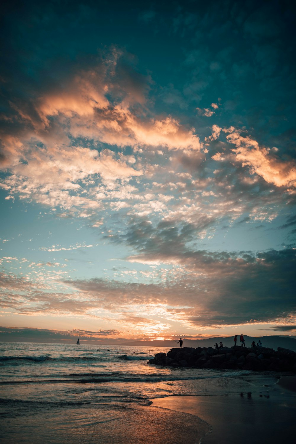 silhouette of people on beach during sunset