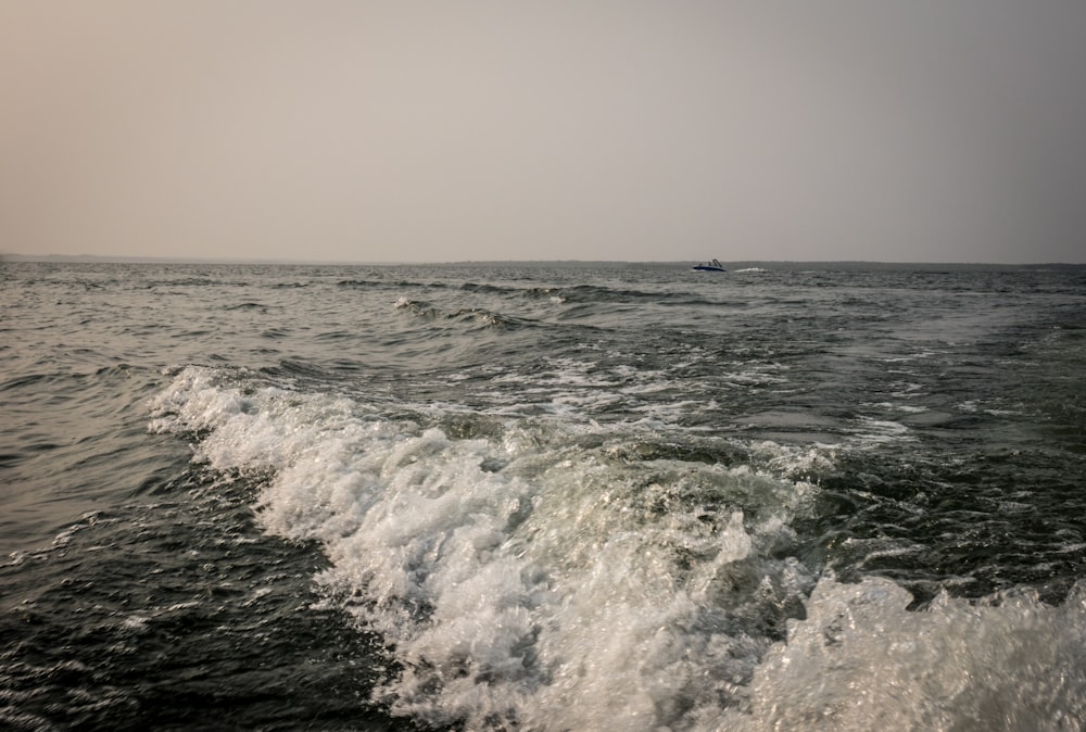 ocean waves crashing on shore during daytime