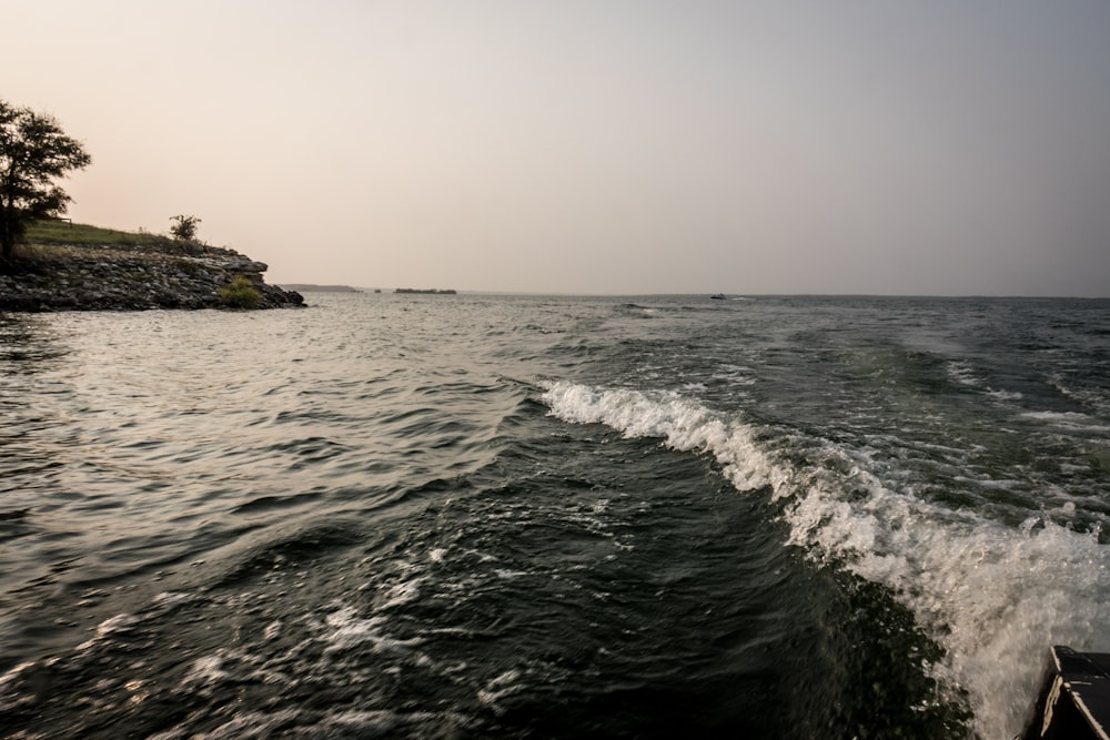 ocean waves crashing on rocky shore during daytime