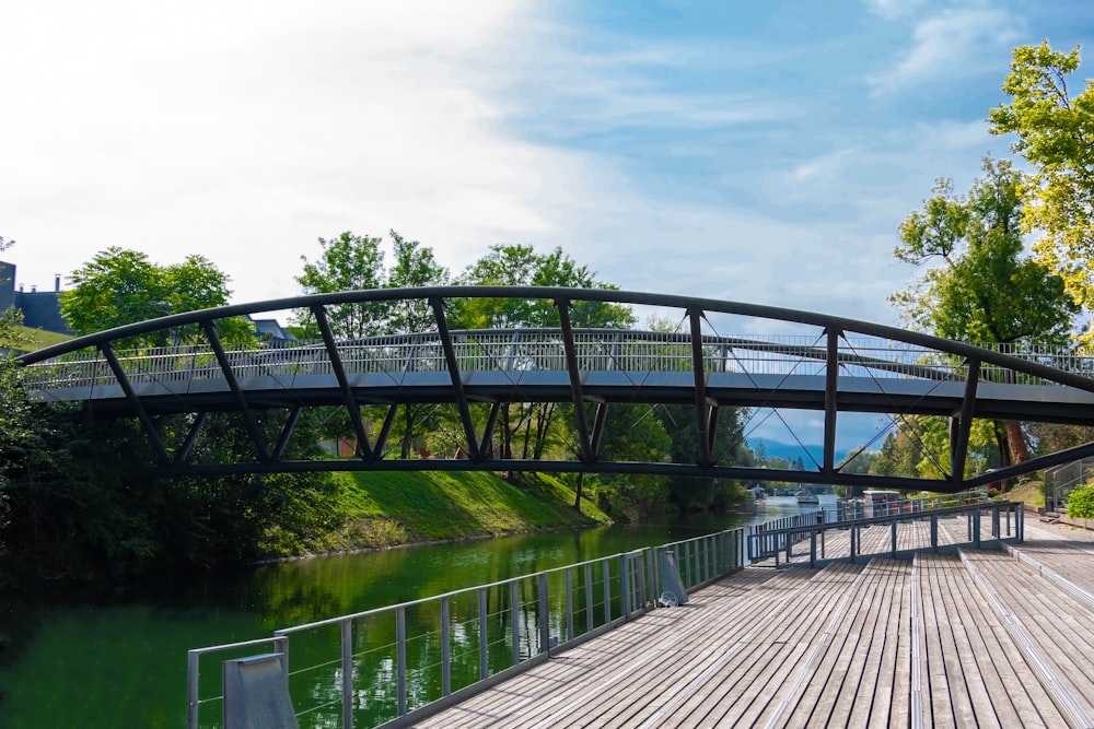 gray wooden bridge over river