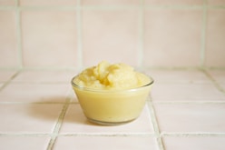 yellow cream in clear glass bowl