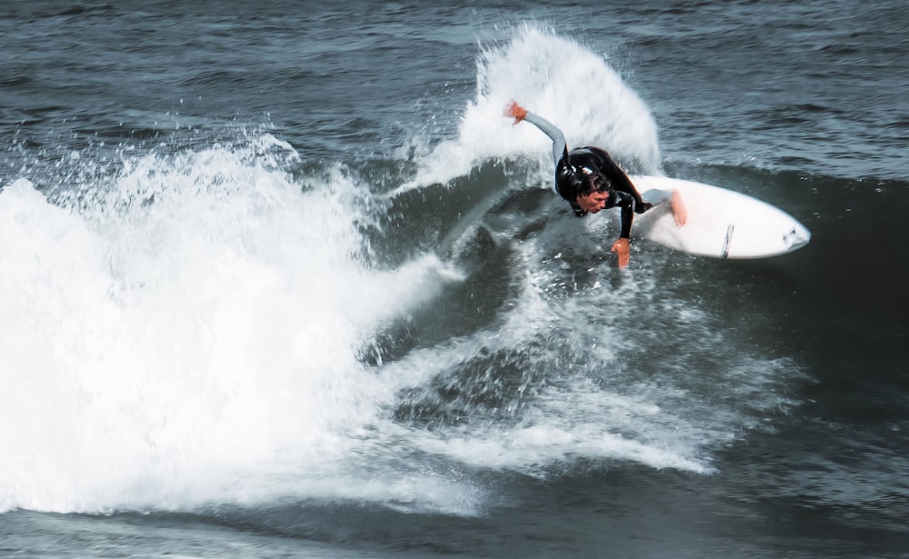 person surfing on sea waves during daytime