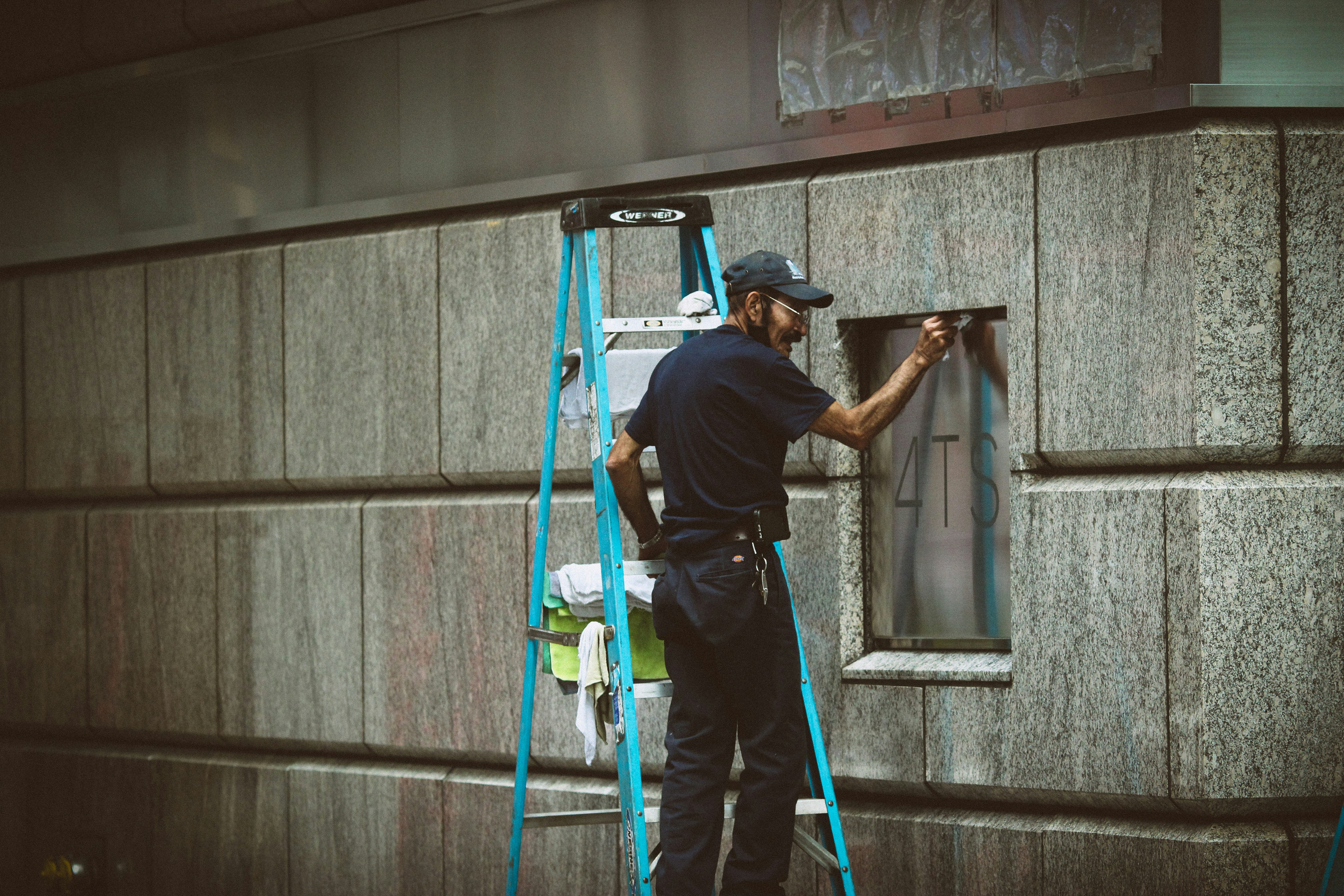 Certified technician performing safety inspection on a commercial door - commercial overhead door service