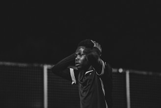 A thoughtful moment of a sub 17 player reflecting on the field, embodying mental strength.