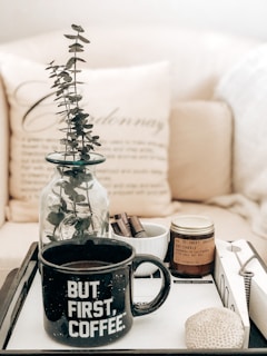 a tray with a coffee mug and a plant on it