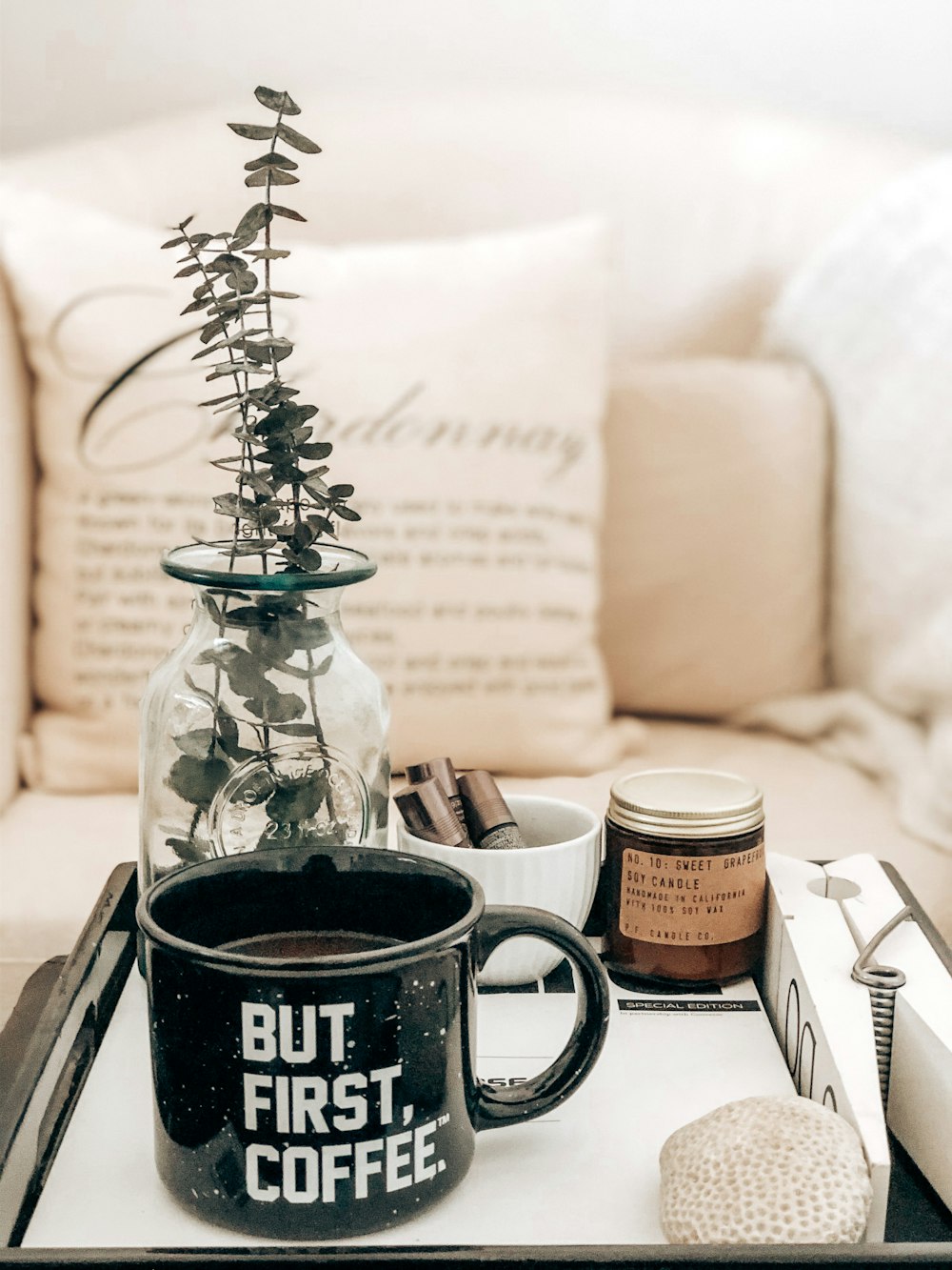 a tray with a coffee mug and a plant on it