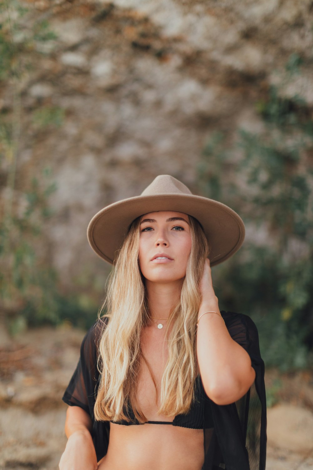 woman in black shirt wearing brown hat