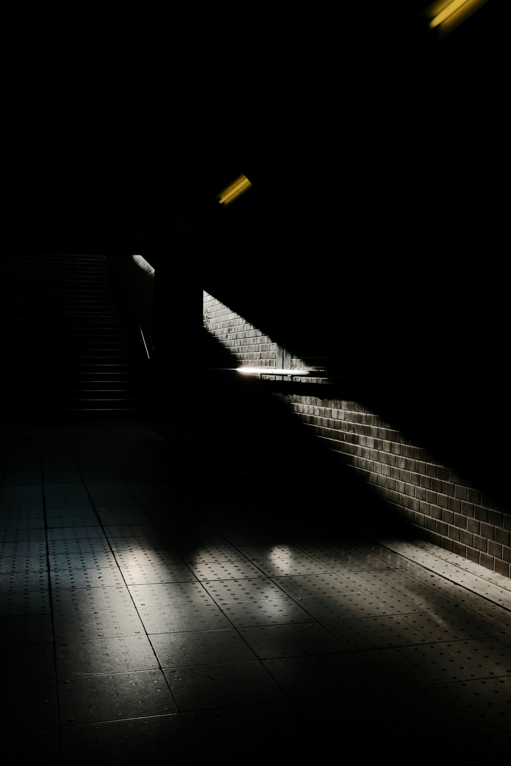 grayscale photo of brick floor