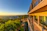 Elegant suite balcony overlooking Cartagena's historic skyline at sunset.