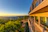 Elegant suite balcony overlooking Cartagena's historic skyline at sunset.