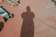 person in black shoes standing on brown concrete floor