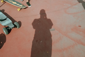 person in black shoes standing on brown concrete floor