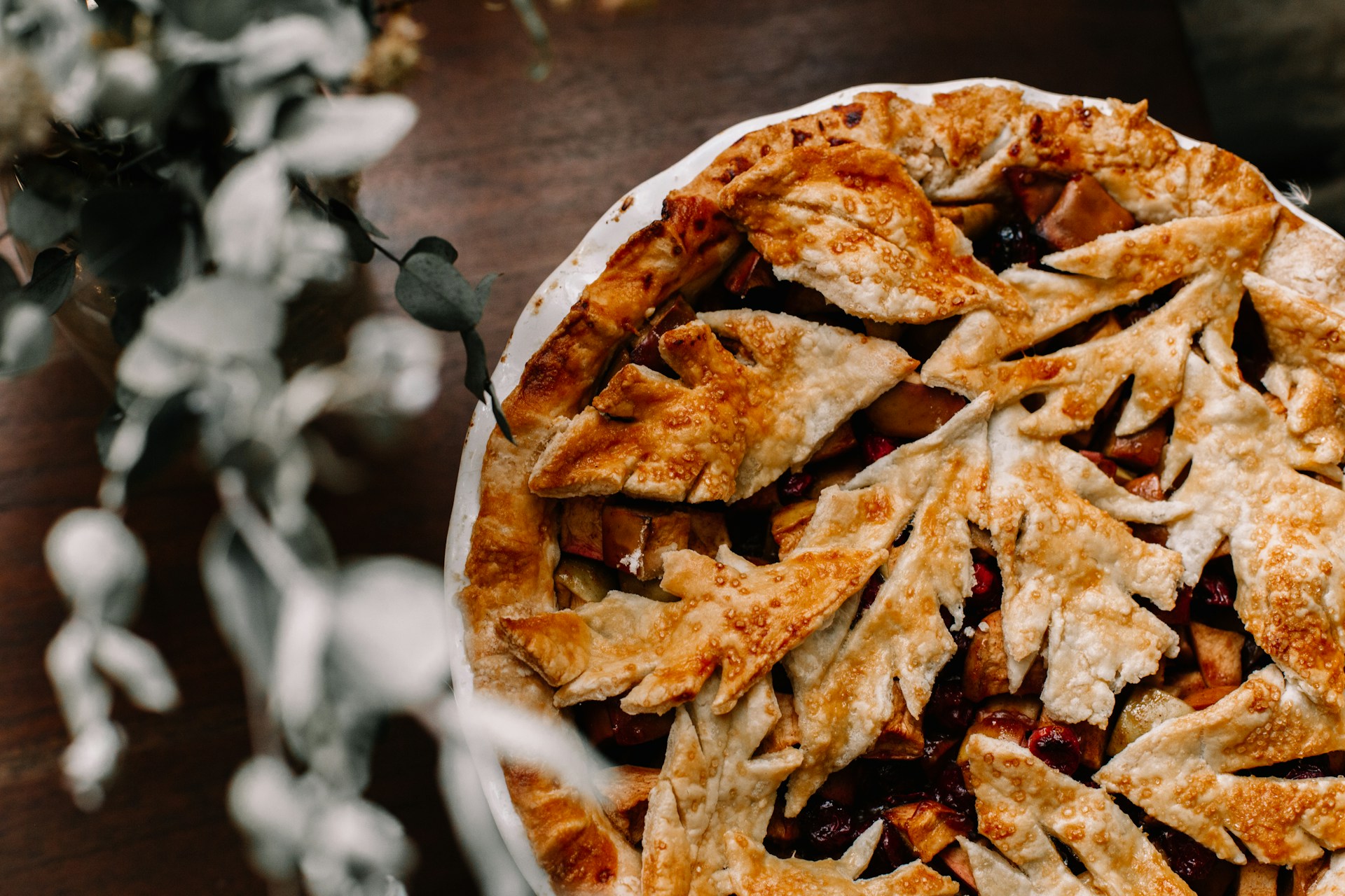 A close-up of a delicious pay (pie) with a flaky crust and colorful filling, garnished with fresh fruits.