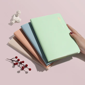 person holding green covered book